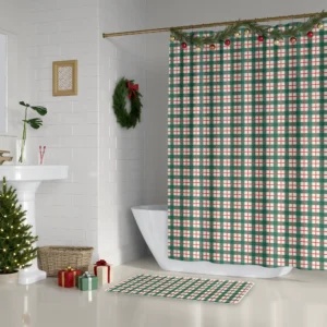 Green check Christmas shower curtain beside a white tub, with a wreath and a small lit tree