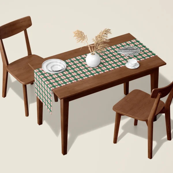 Green check Christmas table runner on a walnut dining table with two wooden chairs