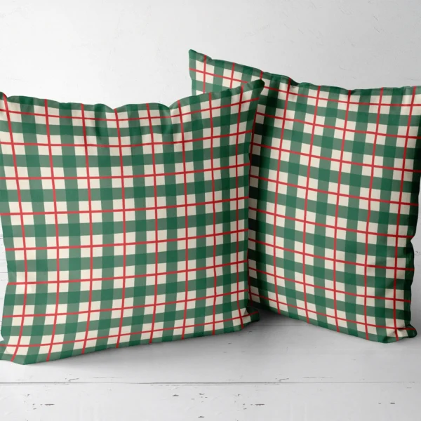 Two green check throw pillows standing side by side