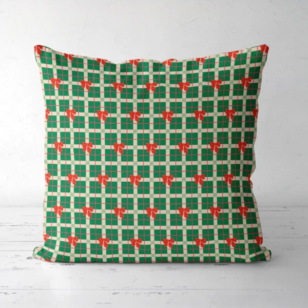 Green plaid bow Christmas pillow, front view, standing on a white floor