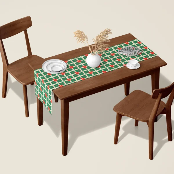 Green plaid with red bows Christmas table runner on a walnut dining table with two wooden chairs