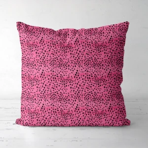 Hot pink spotted throw pillow, front view, on a white floor