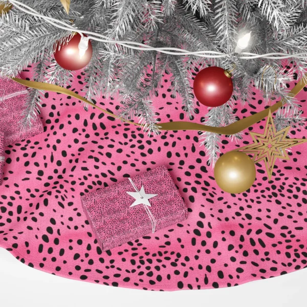 Close-up of the print: black ovals, pebble spots and tiny specks on hot pink