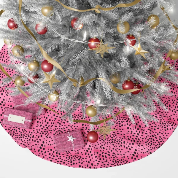 Pink spotted skirt under a lit Christmas tree with wrapped gifts around it