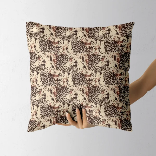 Hand holding the square cream pillow with brown leopard rosettes
