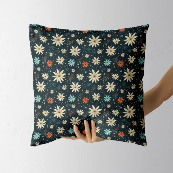 Hand holding the square dark floral starflower pillow
