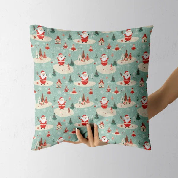 Mint Santa village cushion held up by a hand