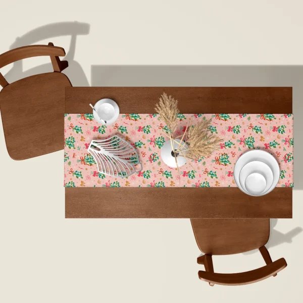 Mistletoe blush Christmas table runner seen from above on a walnut table with white dishes and dried pampas