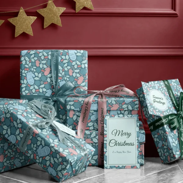 Stack of presents in teal mitten paper with ribbons and a Merry Christmas card by a burgundy wall