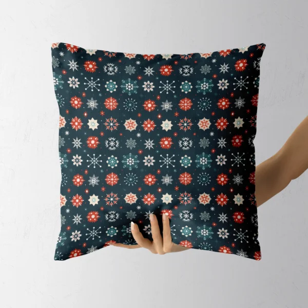 Hand carrying the navy snowflake throw pillow