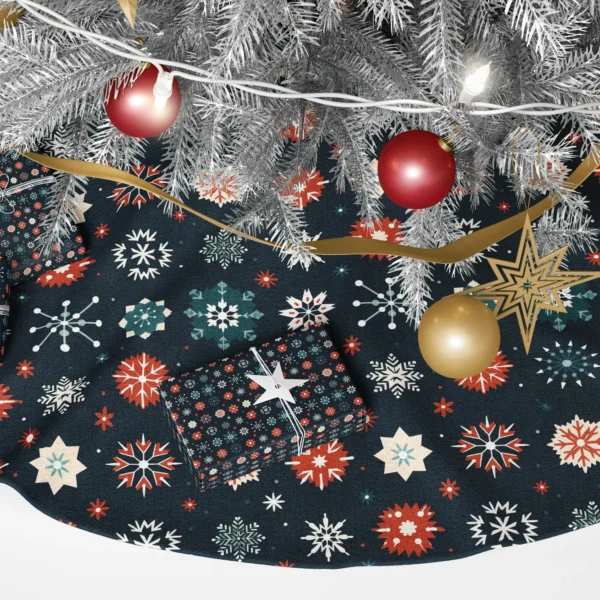 Detail of red, teal and cream geometric snowflakes on dark navy