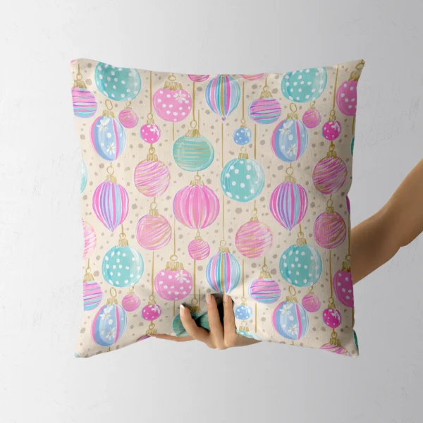 Hand lifting the square cream bauble throw pillow
