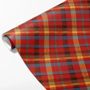 Roll of red patchwork plaid wrapping paper with uneven gold, blue, green and brown bands, partly unrolled on white