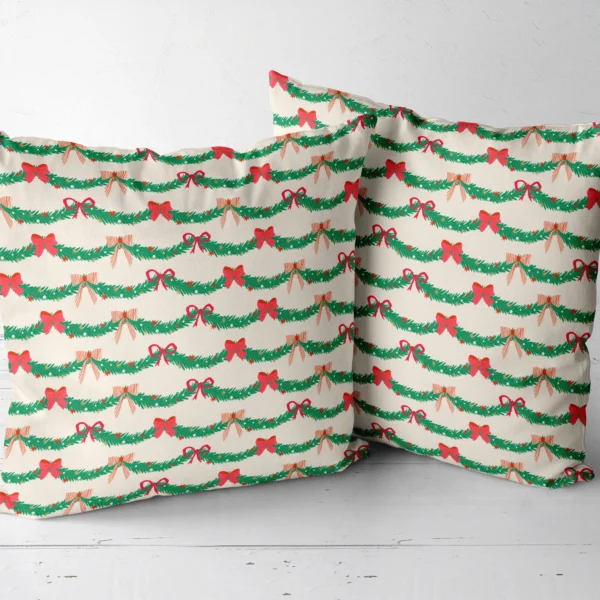 Two pine garland throw pillows placed side by side