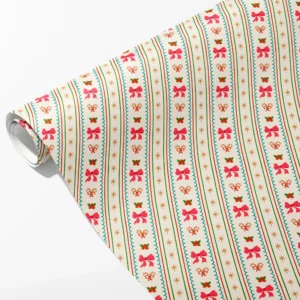 Roll of cream wrapping paper with pink bows, candy canes and holly in teal scalloped stripes, partly unrolled on white
