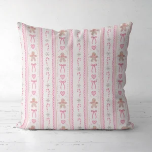 Pink gingerbread Christmas pillow facing forward on a white floor