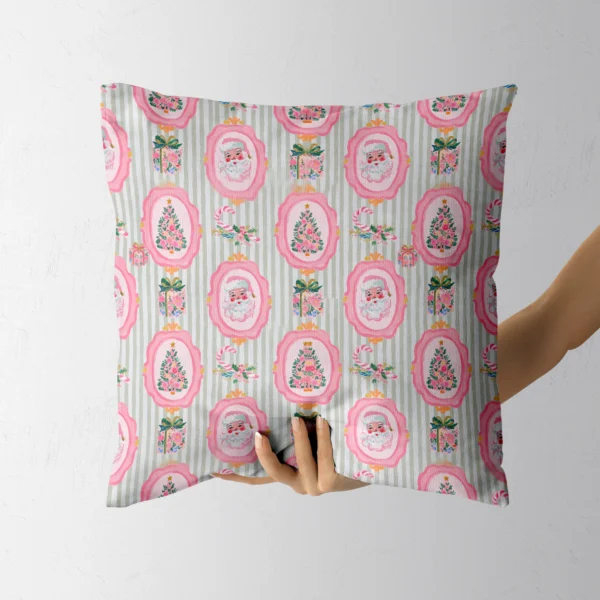 Hand holding the sage-stripe pink Santa throw pillow