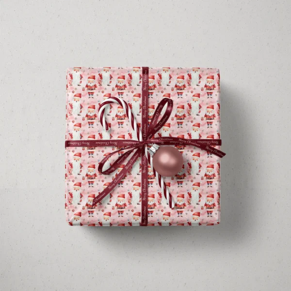 Top view of a gift in pink watercolor Santa paper with a ribbon, a candy cane and a bauble