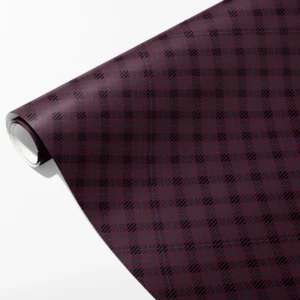 Roll of plum wrapping paper with hatched black plaid blocks and fine teal lines, partly unrolled on white