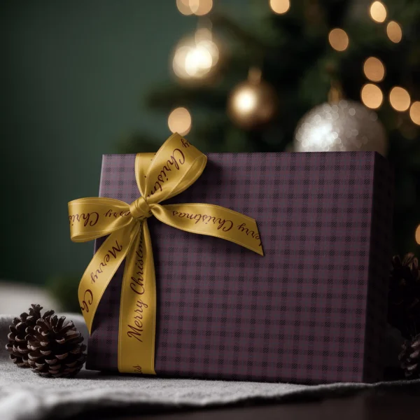 Box wrapped in plum and black plaid paper with a satin ribbon bow and string lights behind