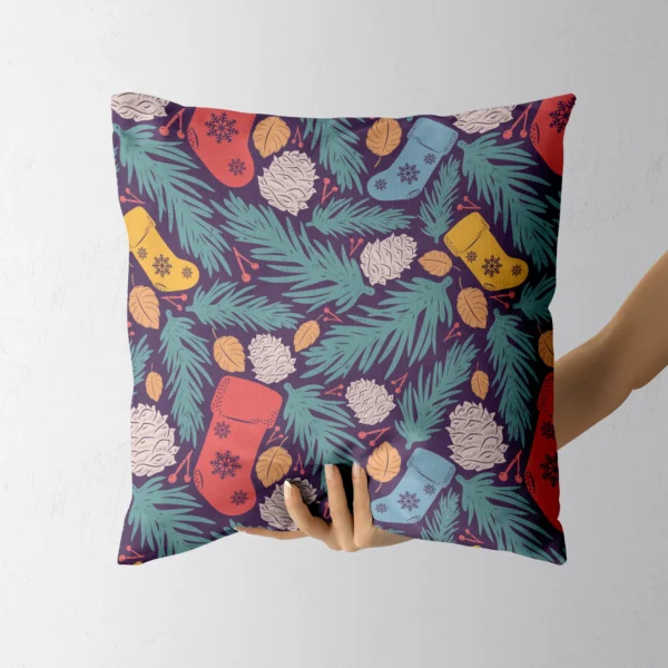 Hand holding the deep plum pillow with colorful stockings