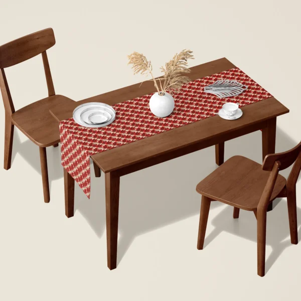 Red poinsettia Christmas table runner on a walnut dining table with two wooden chairs