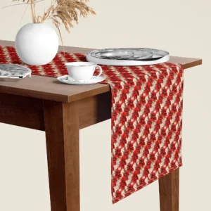 Red poinsettia Christmas table runner hanging over the end of a walnut dining table, close-up