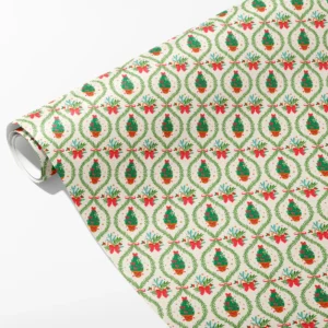 Roll of cream wrapping paper with potted Christmas trees in green garland ovals and red bows, partly unrolled on white
