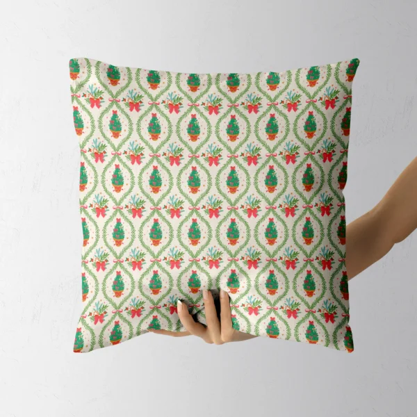 Hand holding the cream pillow with framed potted trees