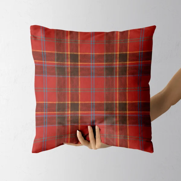 Hand holding the scarlet and black block plaid throw pillow