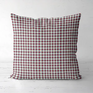 Red and blue gingham pillow standing on a white floor, front view
