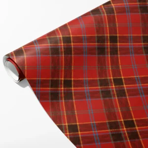Roll of scarlet wrapping paper with near-black block plaid and fine gold, blue and green lines, partly unrolled on white