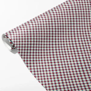 Roll of cream wrapping paper with a red and dusty blue gingham check, partly unrolled on white