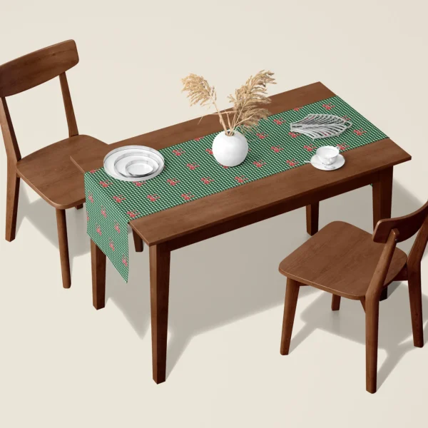 Red bow gingham Christmas table runner on a walnut dining table with two wooden chairs