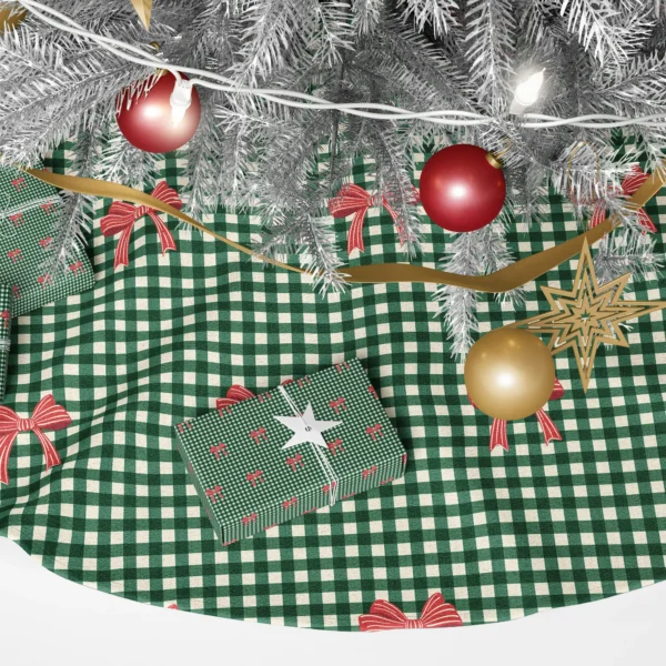Close-up of small red ribbon bows with cream accents on forest green micro gingham
