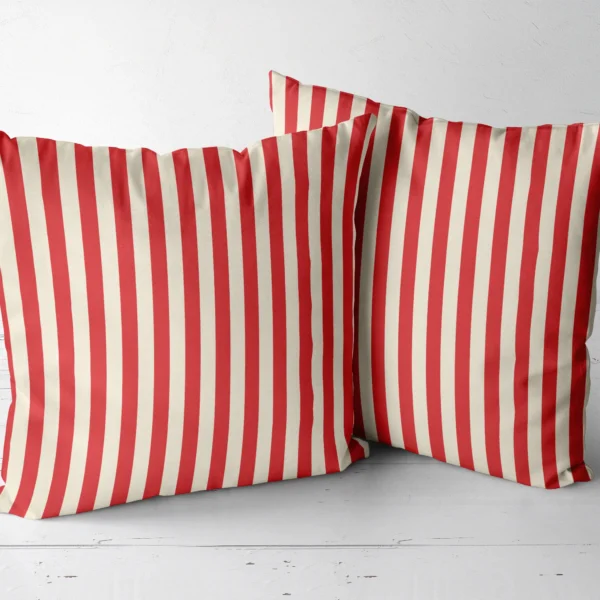 Two red cabana stripe throw pillows next to each other