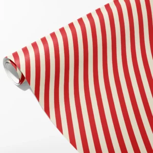Roll of red and cream striped wrapping paper with even vertical stripes, partly unrolled on white