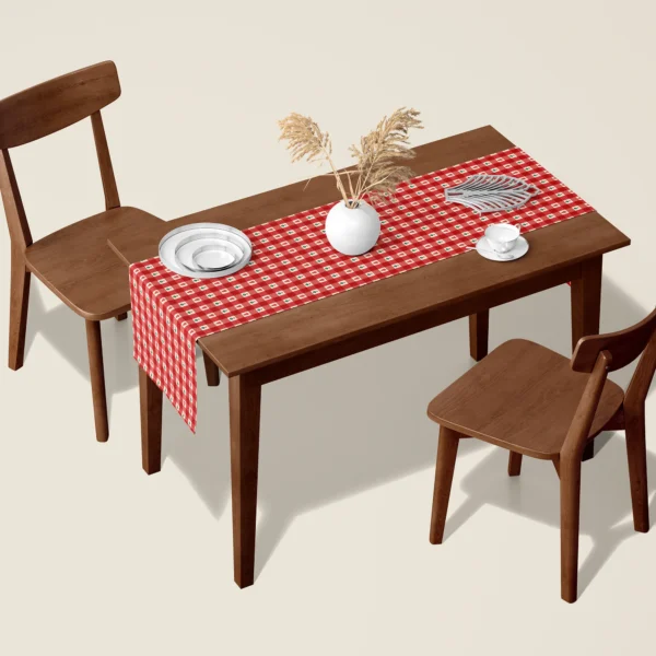 Red gingham tiny tree Christmas table runner on a walnut dining table with two wooden chairs