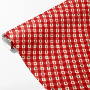 Roll of red gingham wrapping paper with tiny red trees and green flowers in the cream squares, partly unrolled on white