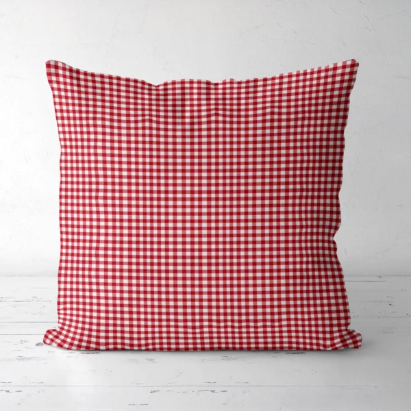 Red gingham throw pillow, front view, on a white floor