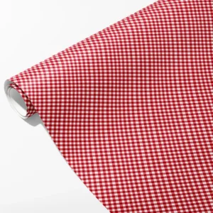 Roll of red and white gingham wrapping paper with a small even check, partly unrolled on white