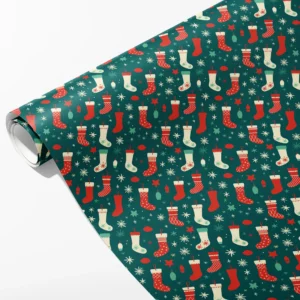 Roll of deep teal wrapping paper with red and cream Christmas stockings, baubles and starbursts, partly unrolled on white