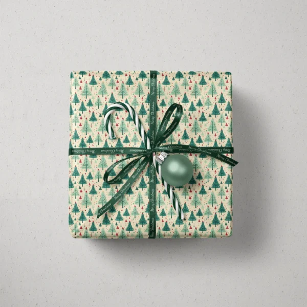 Top view of a gift in cream retro green tree paper with a ribbon, a candy cane and a bauble