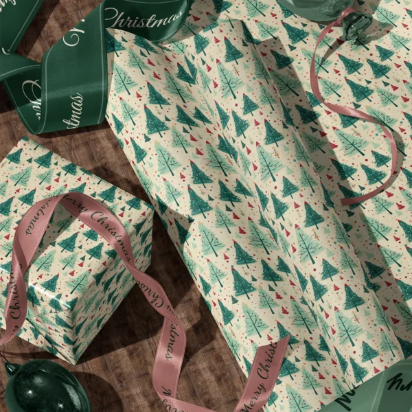 A sheet of cream retro green tree gift wrap and a wrapped box with satin ribbons on a wooden floor