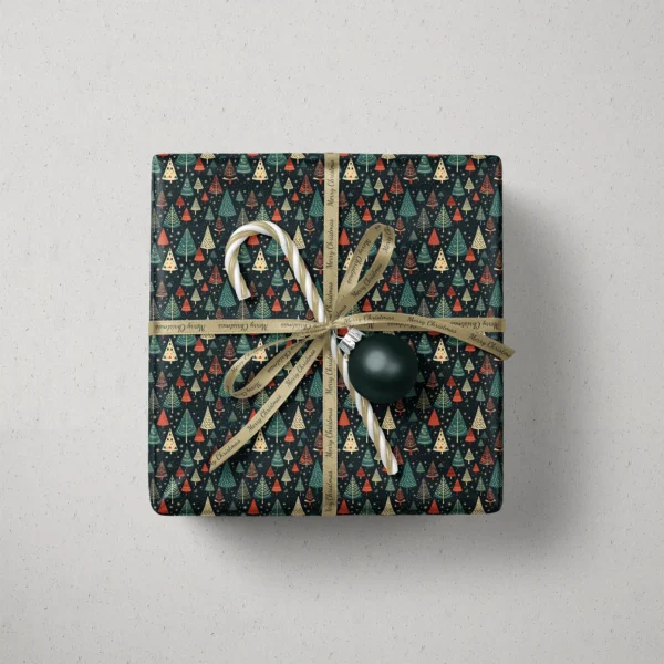 Top view of a gift in starry navy tree paper with a ribbon, a candy cane and a bauble