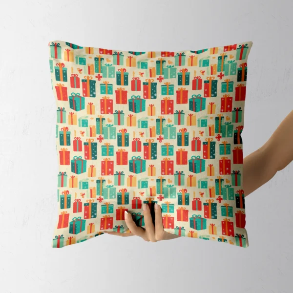Hand holding the square cream pillow covered in retro gift boxes