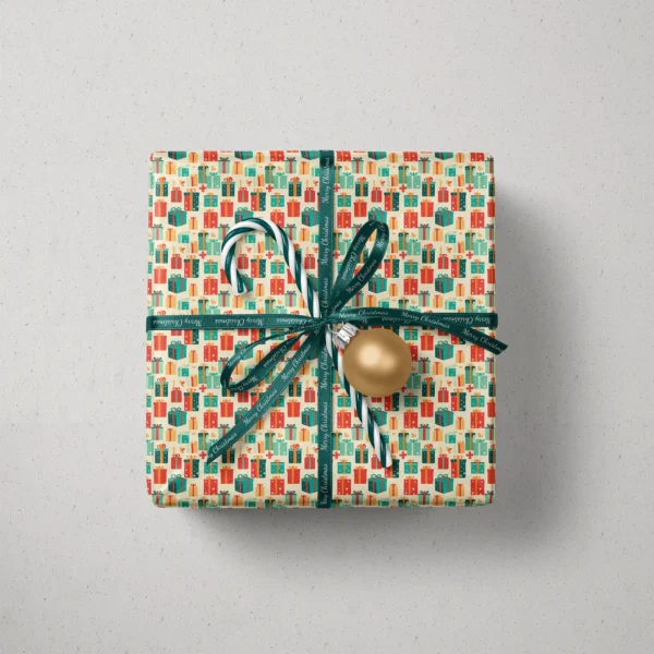 Top view of a gift in retro present paper with a ribbon, a candy cane and a bauble