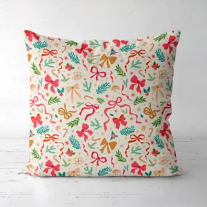 Ribbon and greenery Christmas pillow, front view, pink and red bows on cream