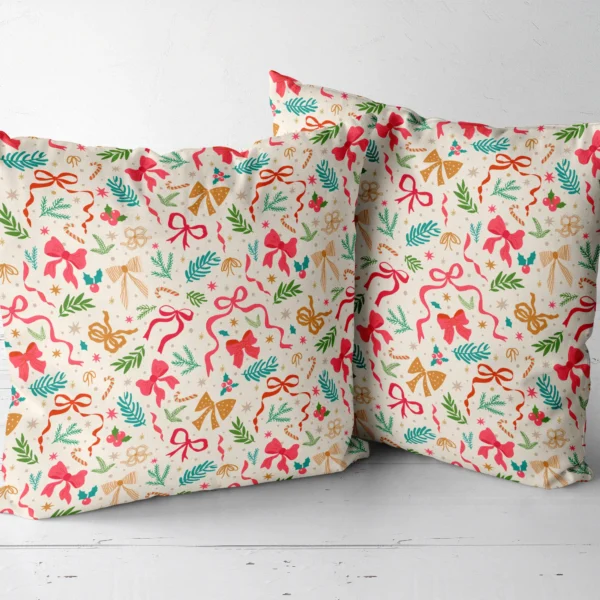 Two bow and greenery throw pillows side by side