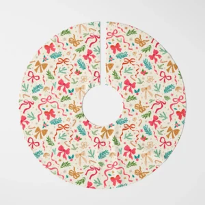 Ribbon and greenery tree skirt laid flat, top view of pink, red and gold bows on cream